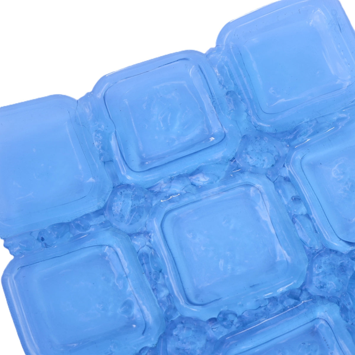 A close-up of a translucent sapphire blue glass bowl with square elements and organic frit, shown on a plain white background