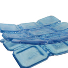 A sapphire blue translucent square glass bowl, arranged in a mirror with a white background.